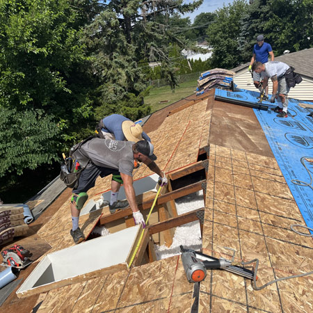 Henson Building Crew Replacing a Home's Roof